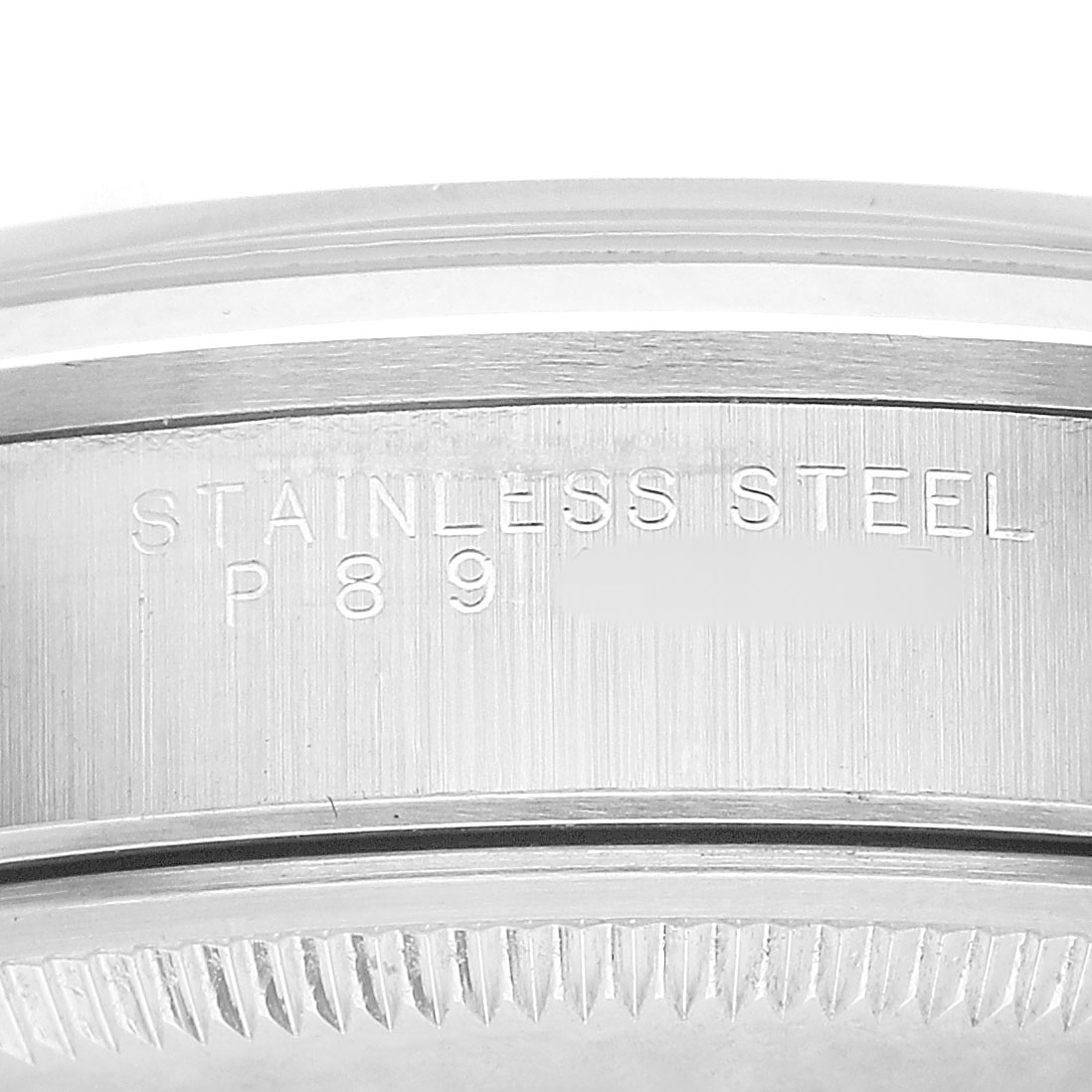 The image shows the side profile of a Rolex Air-King 14000M Men's Stainless Steel Blue Dial watch, focusing on its stainless steel case and engraved text.