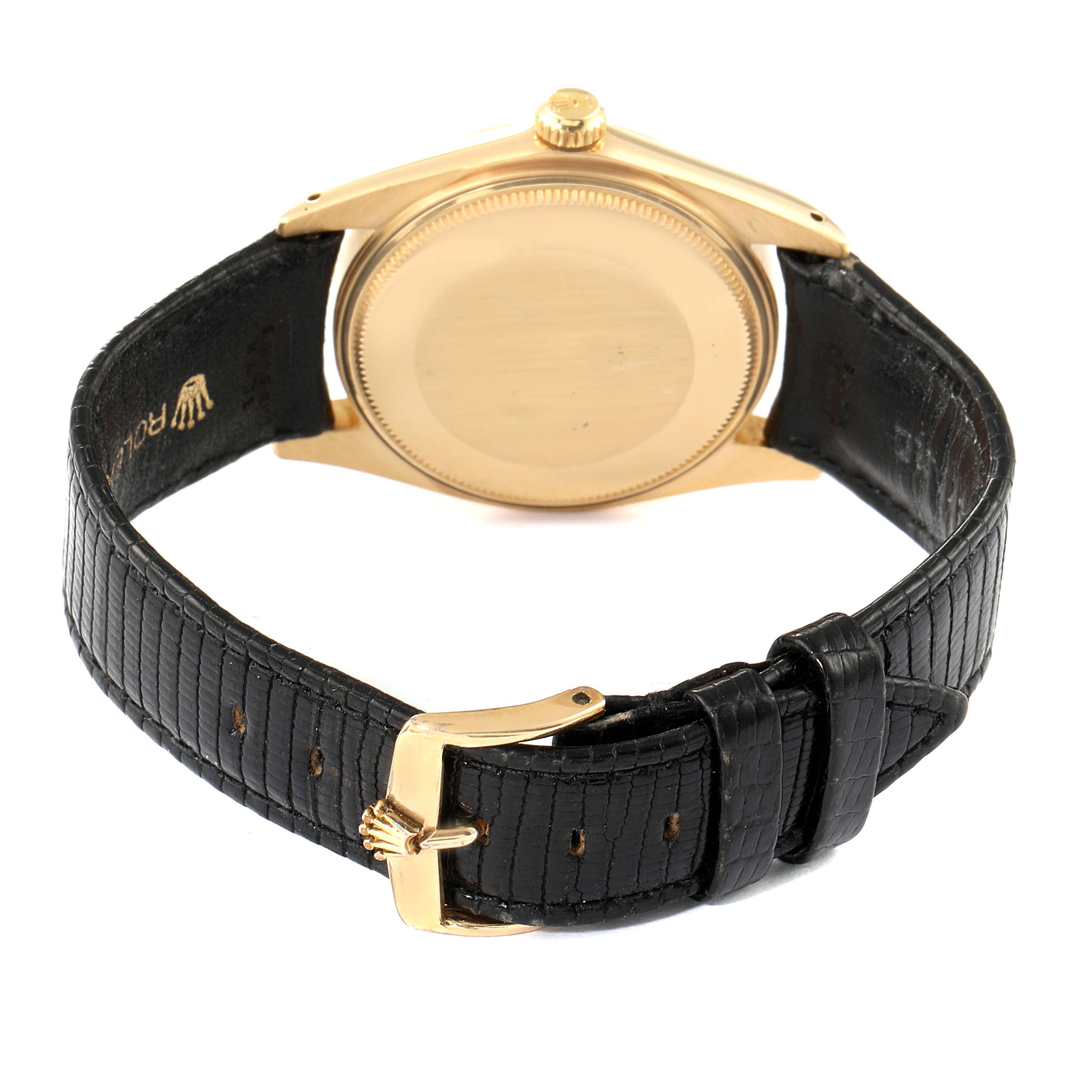 This image shows the back view of a Rolex Date 1502 Men's Yellow Gold Champagne Dial 1502 Men's Yellow Gold Champagne Dial model watch with a black leather strap and gold buckle.