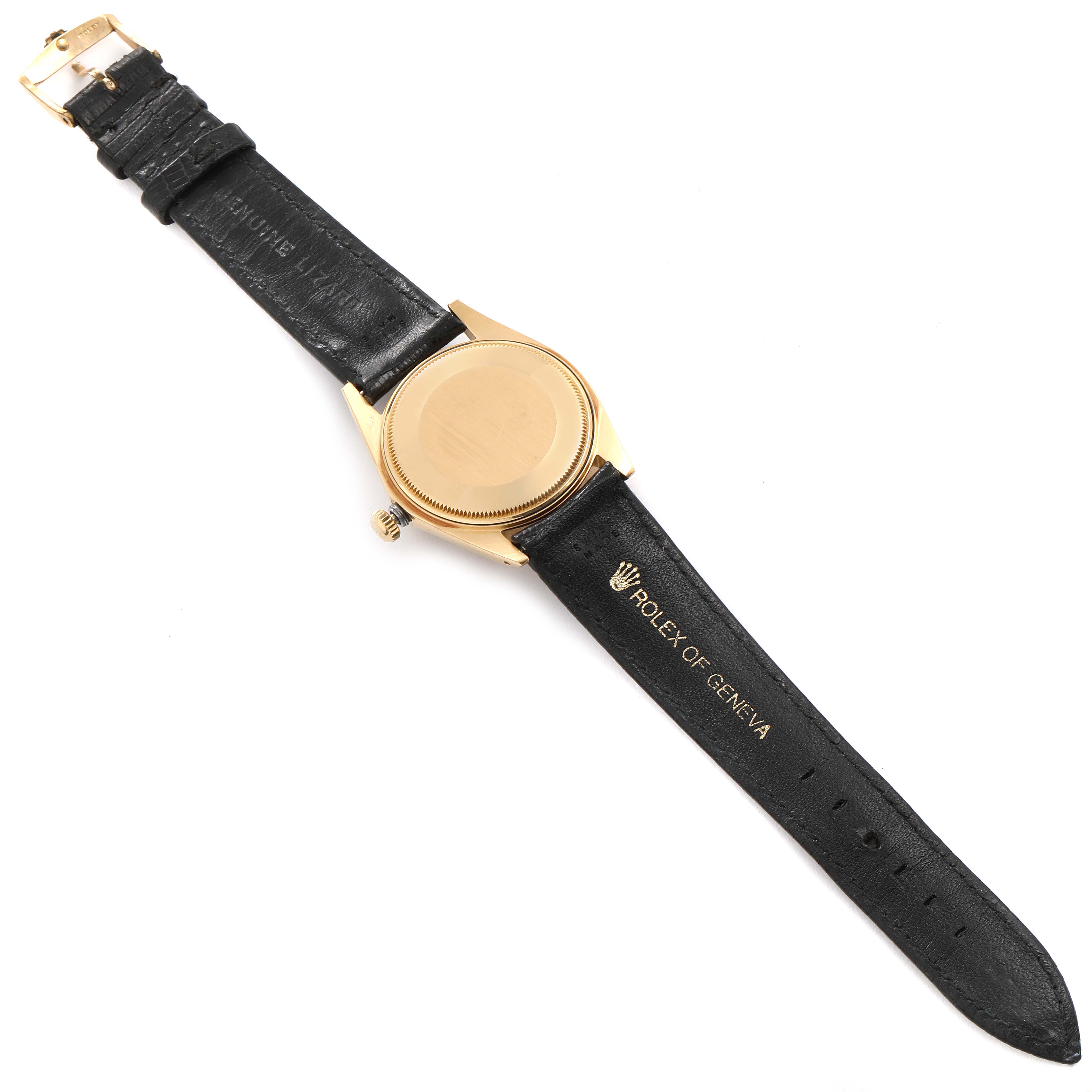 The image shows the back view of a Rolex Date 1502 Men's Yellow Gold Champagne Dial 1502 Men's Yellow Gold Champagne Dial model watch, focusing on the case back and black leather strap.