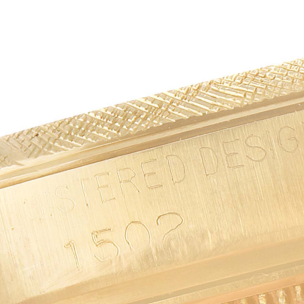 This close-up image shows a portion of the engraved case back of a Rolex Date 1502 Men's Yellow Gold Champagne Dial 1502 Men's Yellow Gold Champagne Dial model, highlighting the text "REGISTERED DESIGN 1502".