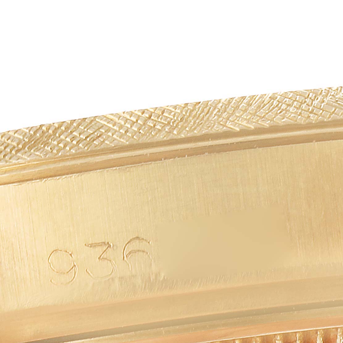 This is a close-up of the edge and serial number of a Rolex Date 1502 Men's Yellow Gold Champagne Dial 1502 Men's Yellow Gold Champagne Dial model watch.
