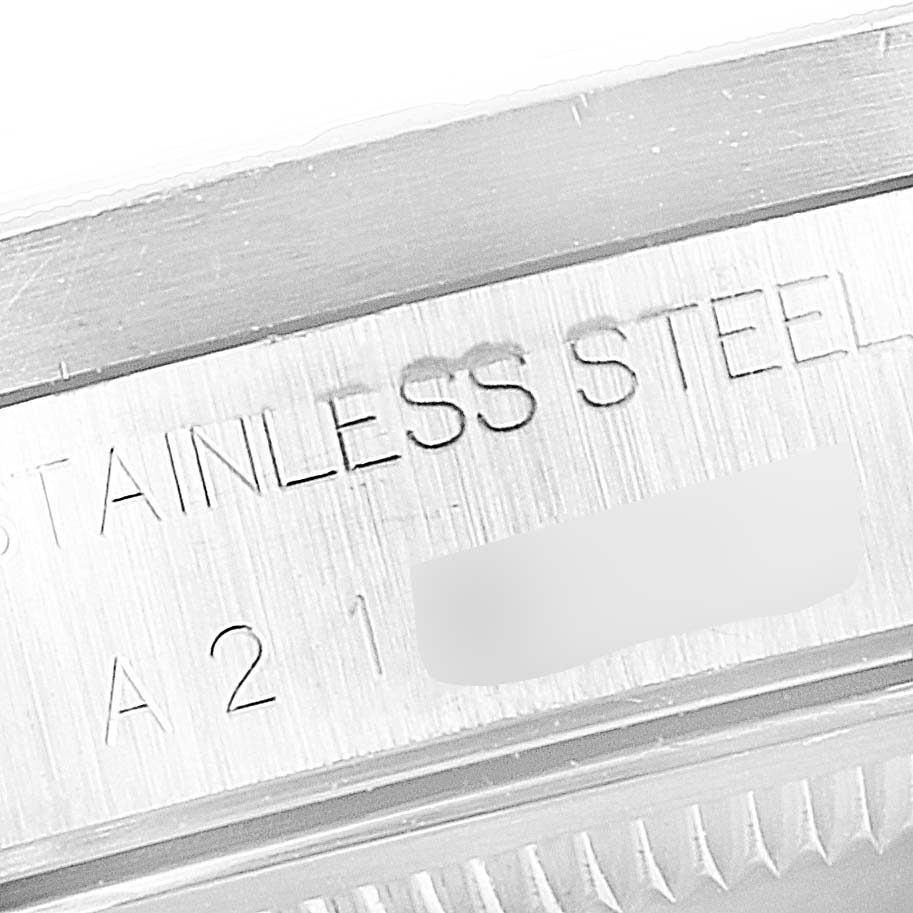 The image shows a close-up of the stainless steel case of a Rolex Date 15210 Men's Stainless Steel Blue Dial 15210 Men's Stainless Steel Blue Dial model watch.