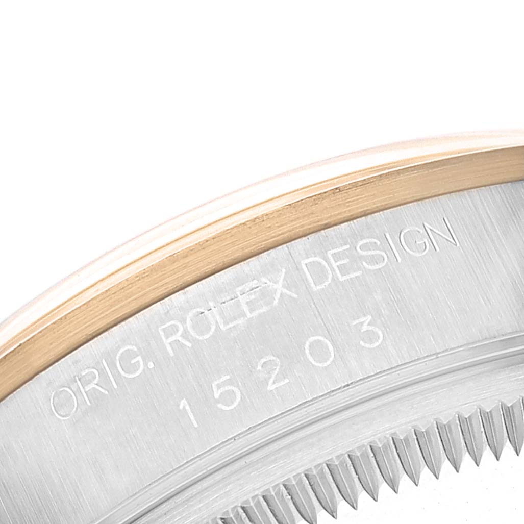 This image shows a close-up of the bezel and casing of the Rolex Date 15203 Men's Steel and Gold (two tone) White Dial 15203 Men's Steel and Gold (two tone) White Dial model, displaying the engraved "ORIG. ROLEX DESIGN" and model number 15203.