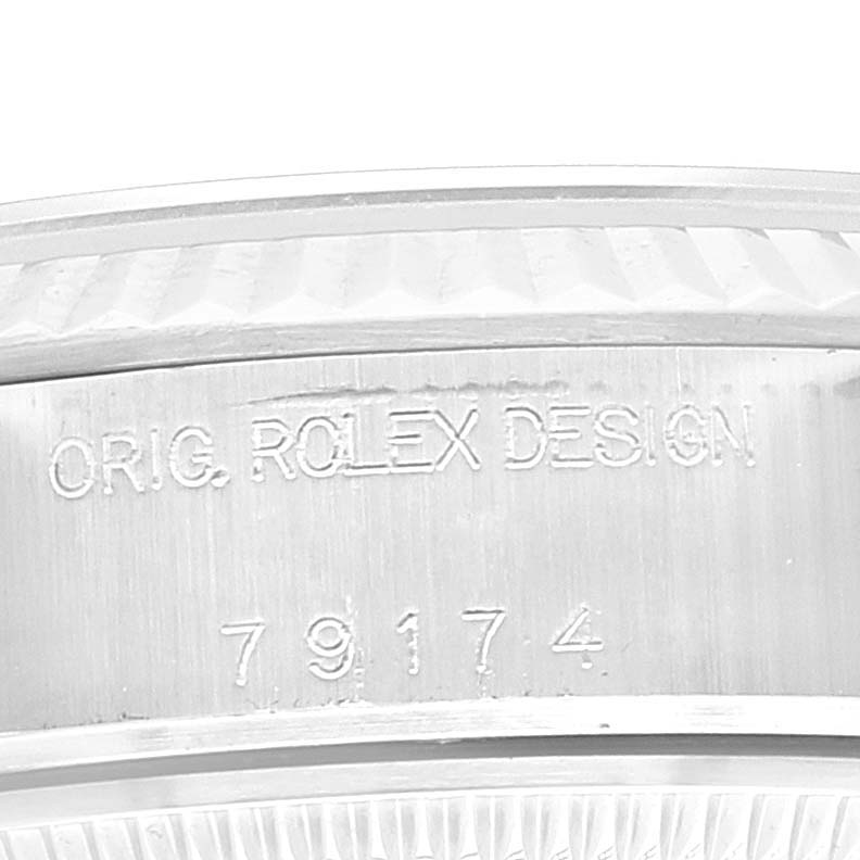 This image shows a close-up of the bezel and engraved serial number of a Rolex Datejust 79174 Women
s Stainless Steel Black Dial 79174 Women
s Stainless Steel Black Dial watch.