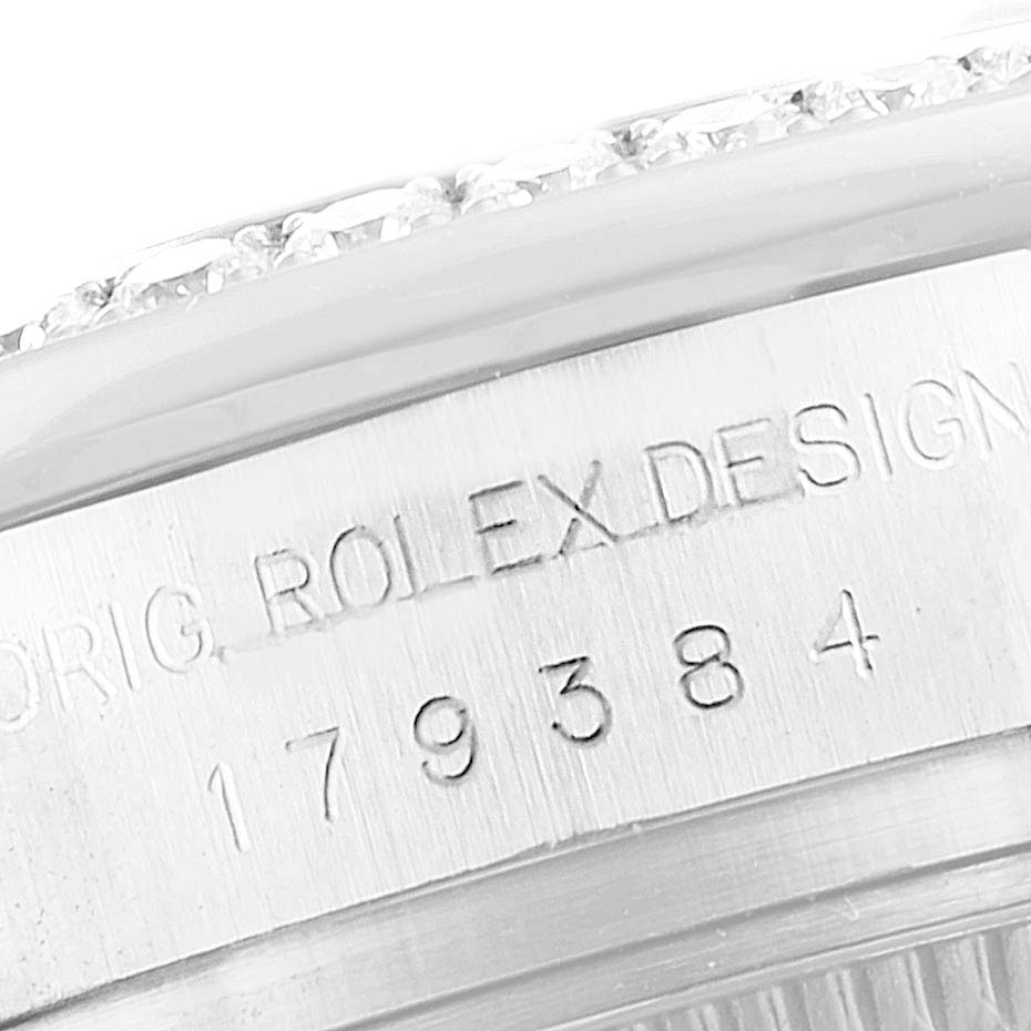 The image shows a close-up of the case side of a Rolex Datejust 179384 Women's Stainless Steel Silver Dial 179384 Women's Stainless Steel Silver Dial watch, highlighting the engraving and part of the bezel.