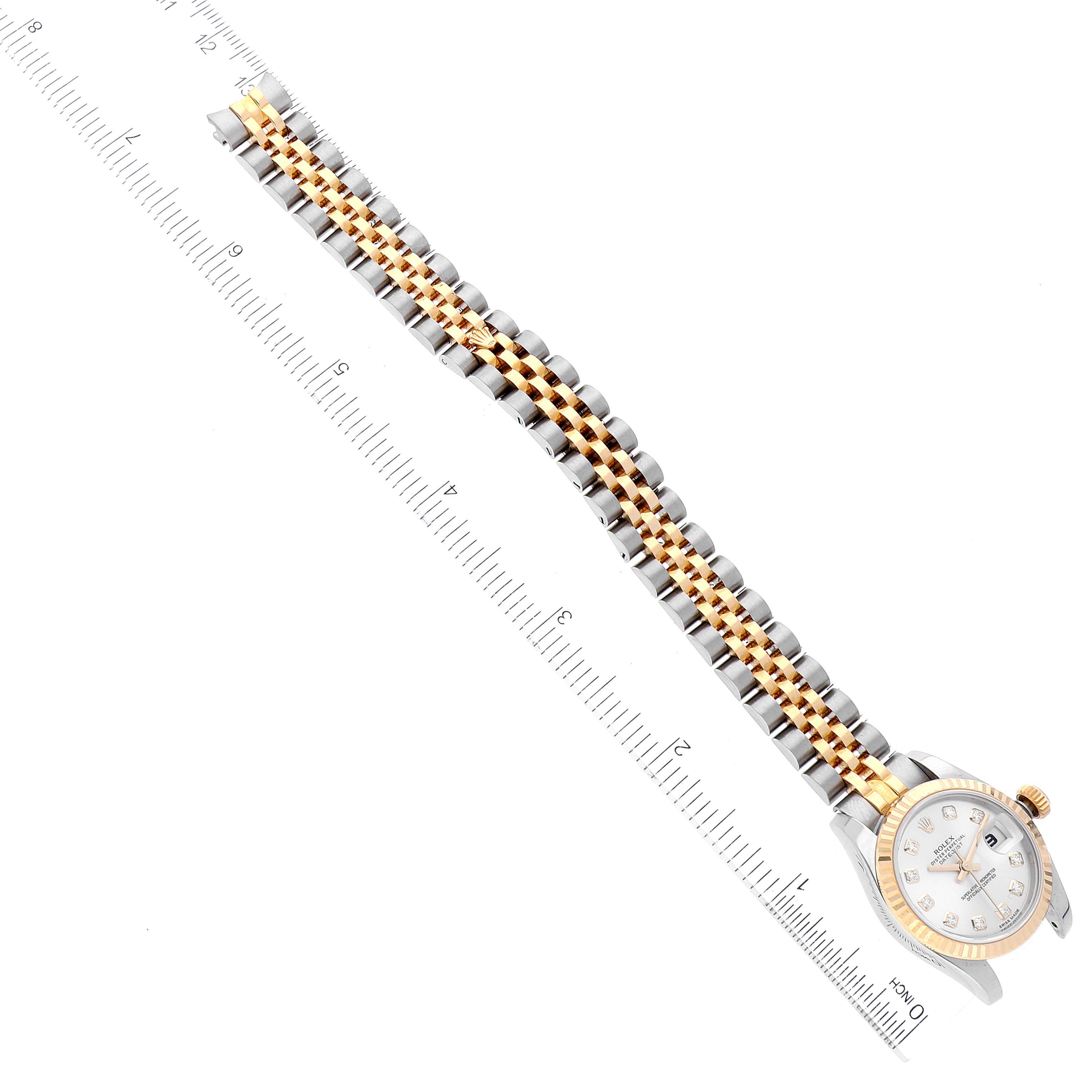 The image shows an angled view of a Rolex Datejust 179173 Women's Steel and Gold (two tone) Silver Dial 179173 Women's Steel and Gold (two tone) Silver Dial watch, highlighting its bracelet and case alongside a measuring ruler.