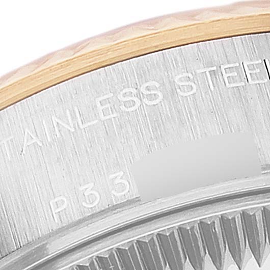 This close-up image of a Rolex Datejust 79173 Women
s Steel and Gold (two tone) Grey Dial 79173 Women
s Steel and Gold (two tone) Grey Dial watch shows the bezel and part of the case back with stainless steel engraving.