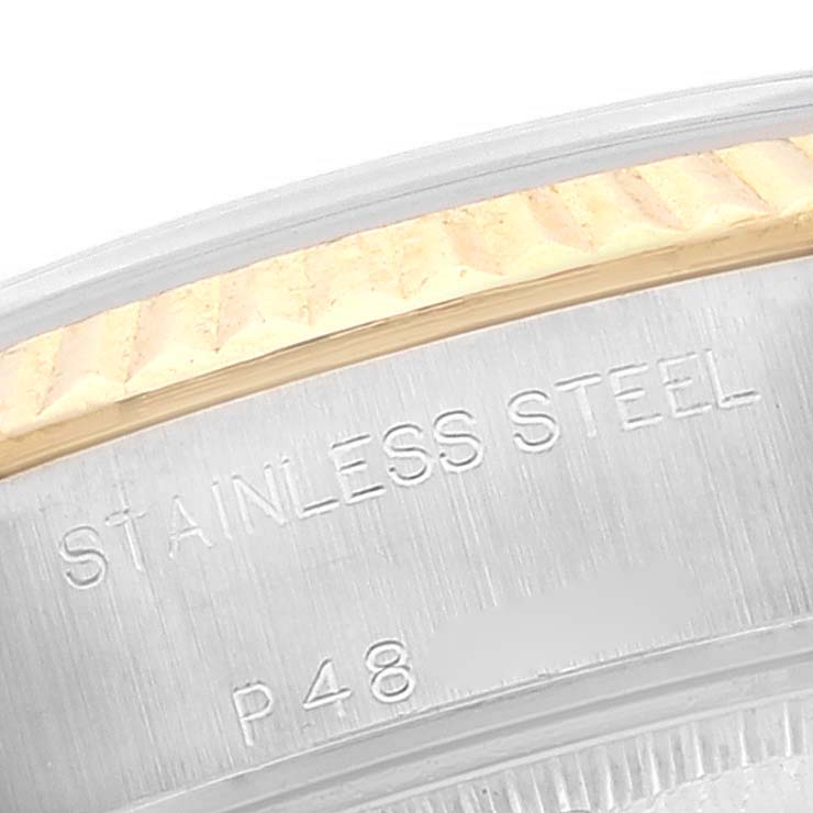 The image shows a close-up of the bezel and case side of a Rolex Datejust 79173 Women's Steel and Gold (two tone) White Dial 79173 Women's Steel and Gold (two tone) White Dial watch, highlighting the stainless steel material and part of the engraved text.