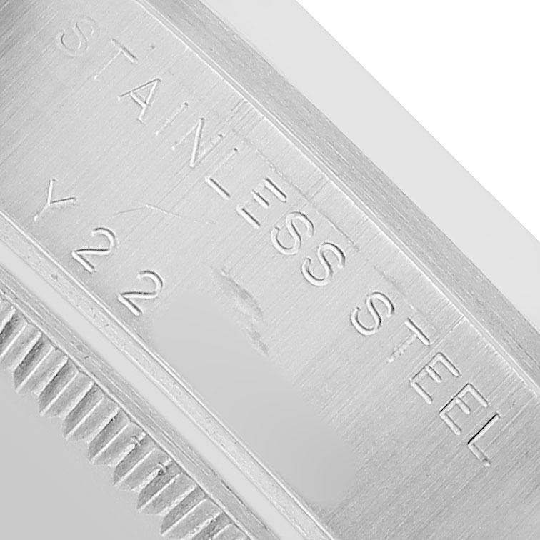 The image shows a close-up of the stainless steel case back edge of a Rolex Mid-Size 78240 Women's Stainless Steel Pink Dial watch, displaying its brushed texture and engraving.