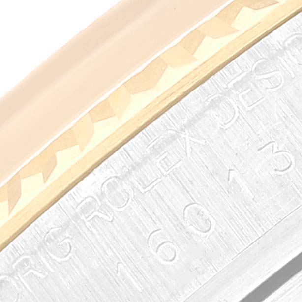 This close-up image shows the side engraving and part of the bezel of the Rolex Vintage Collection 16013 Men
s Steel and Gold (two tone) Champagne Dial 16013 Men
s Steel and Gold (two tone) Champagne Dial watch model, highlighting its details.
