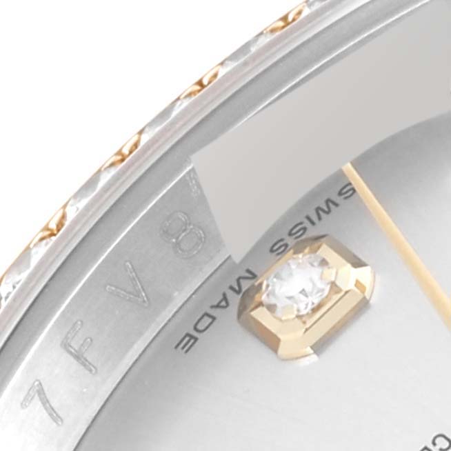 This close-up image of a Rolex Datejust 116243 Men's Stainless Steel Silver Dial 116243 Men's Stainless Steel Silver Dial watch displays part of the bezel, dial, and a diamond marker.
