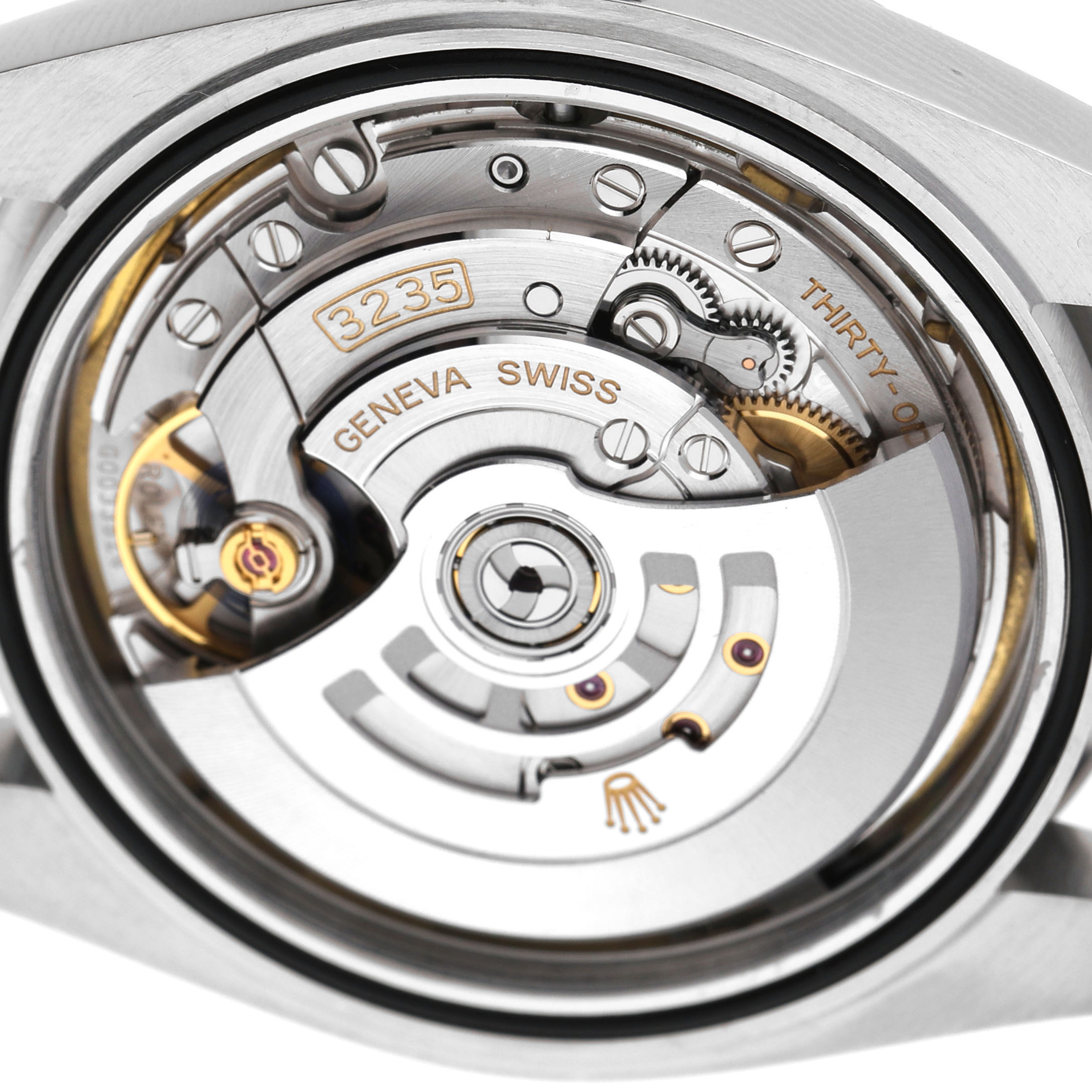 The image shows the movement mechanism of the Rolex Datejust 41 126300 Men's Stainless Steel White Dial from a rear angle, highlighting gears and inscriptions.