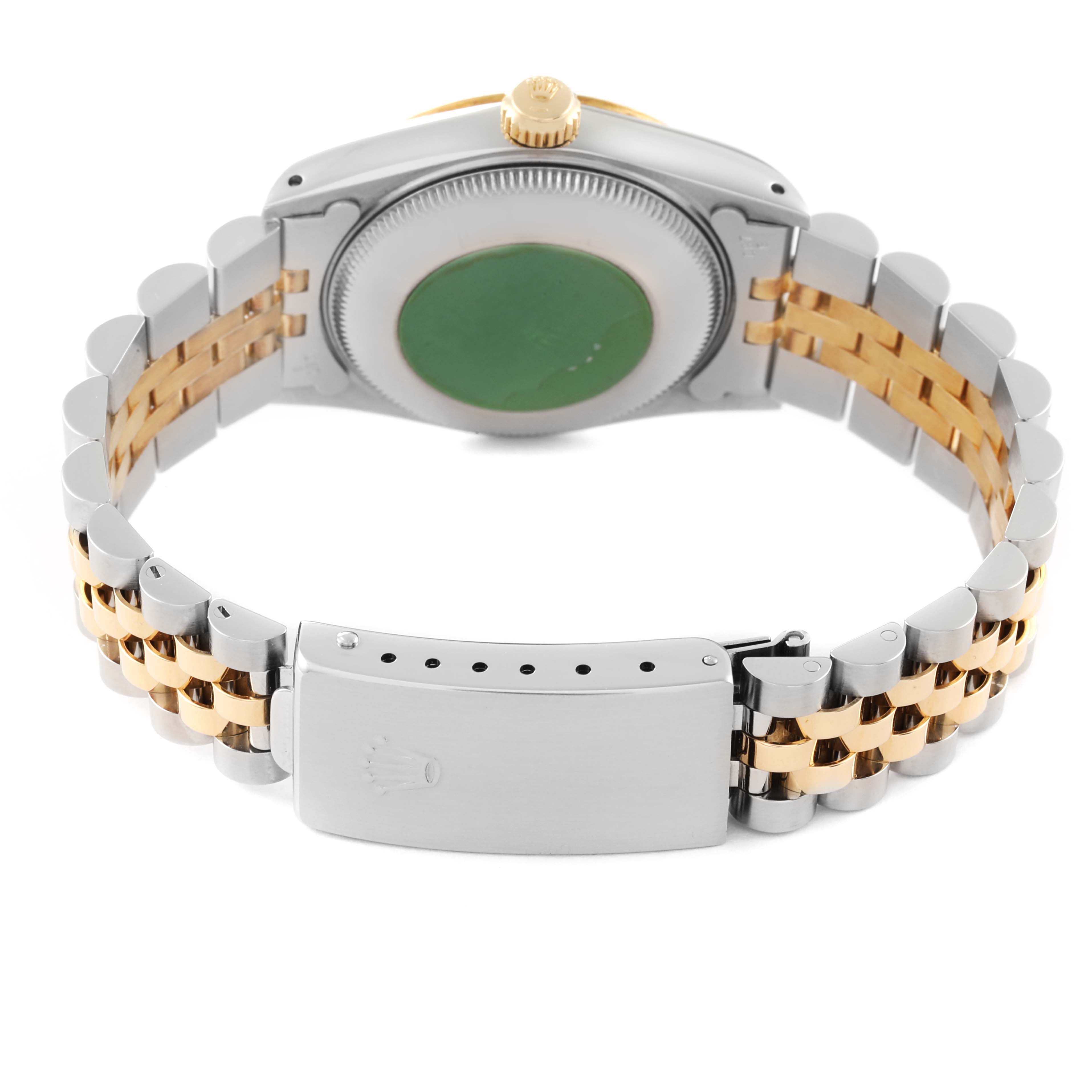 The image shows the back of a mid-size Rolex watch, highlighting the bracelet and clasp.