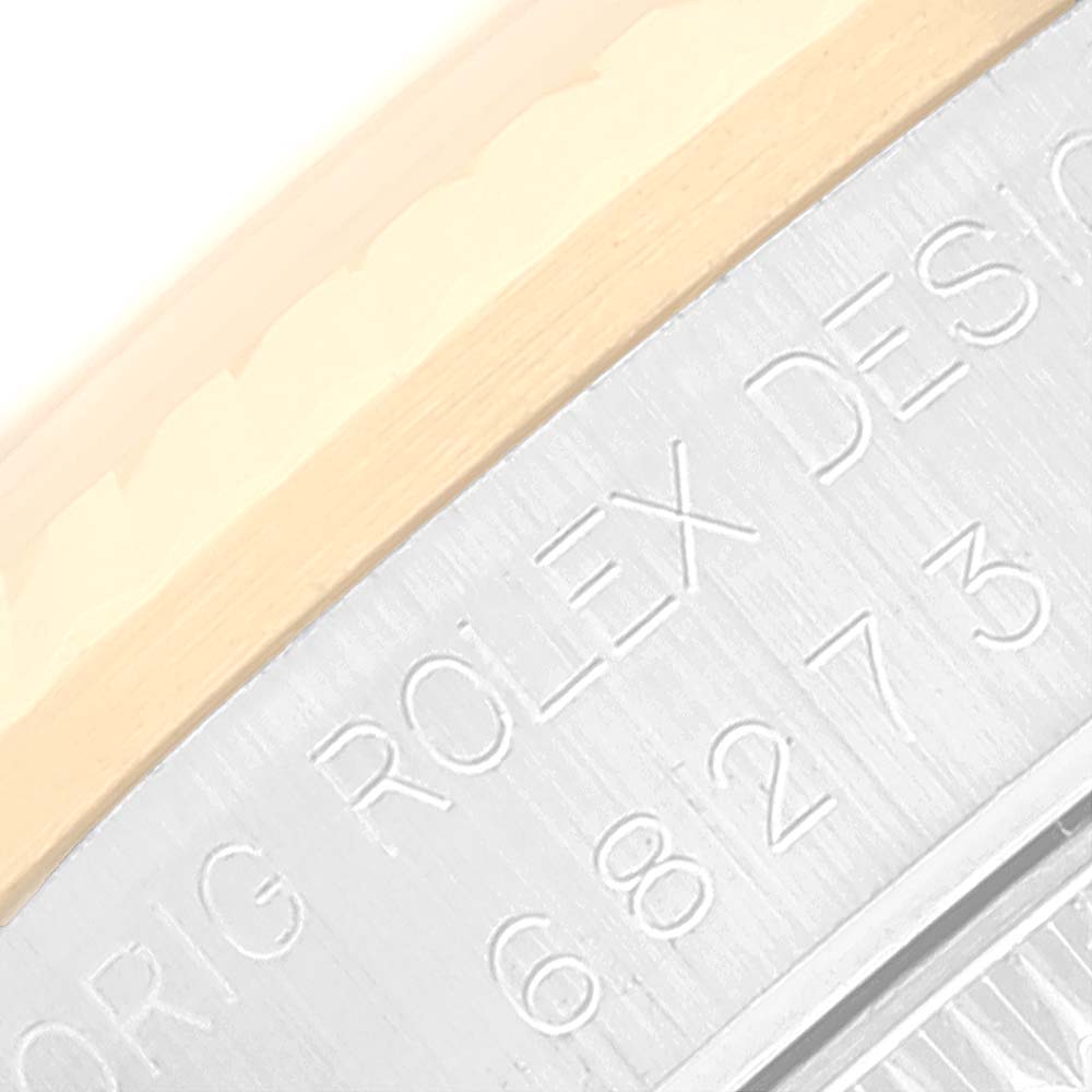 This image shows a close-up of the side casing of a Mid-Size Rolex watch, featuring engraved text.