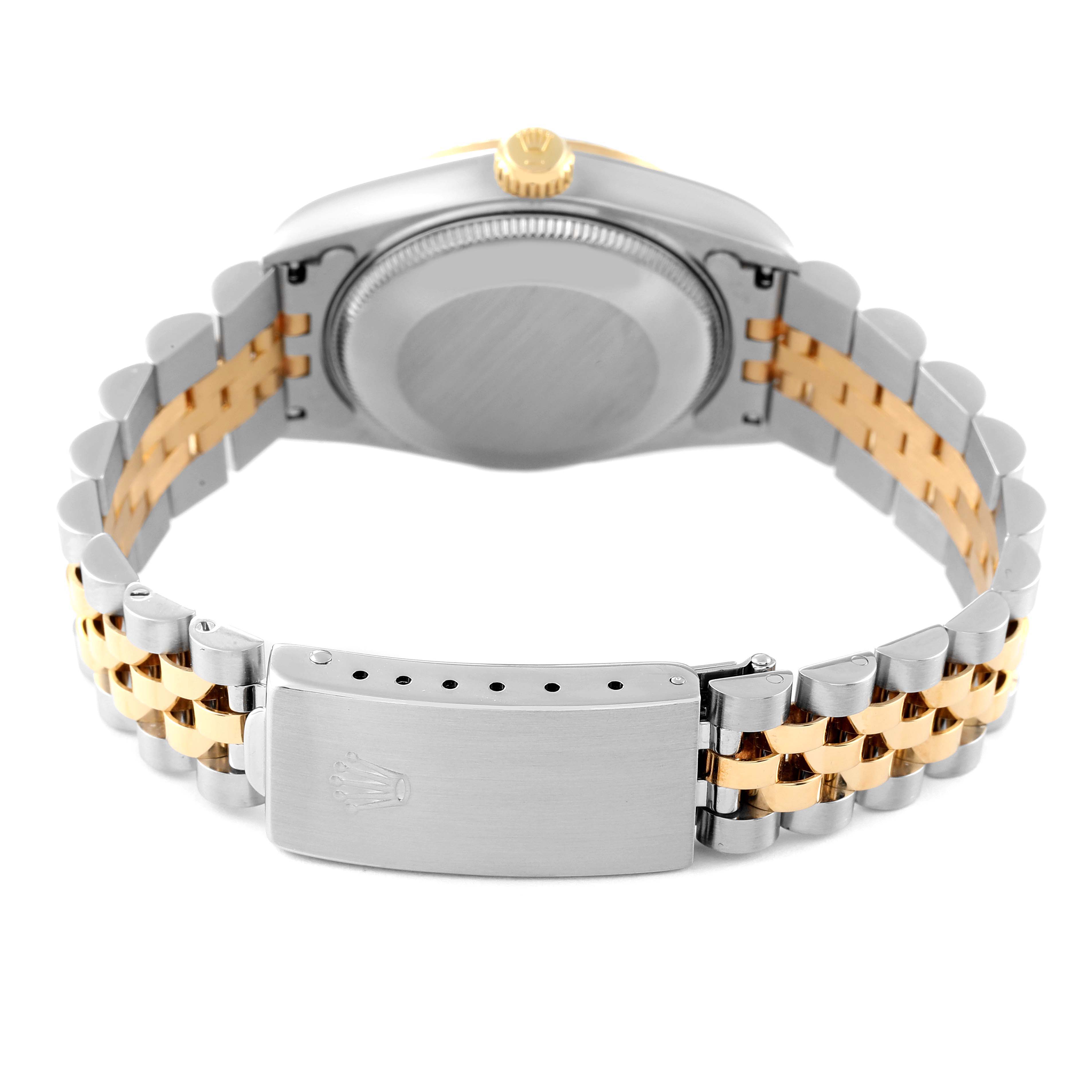 This Rolex Mid-Size 68273 Women
s Steel and Gold (two tone) Black Dial 68273 Women
s Steel and Gold (two tone) Black Dial model is viewed from the back, showing the case, crown, and two-tone metal bracelet with a closed clasp.