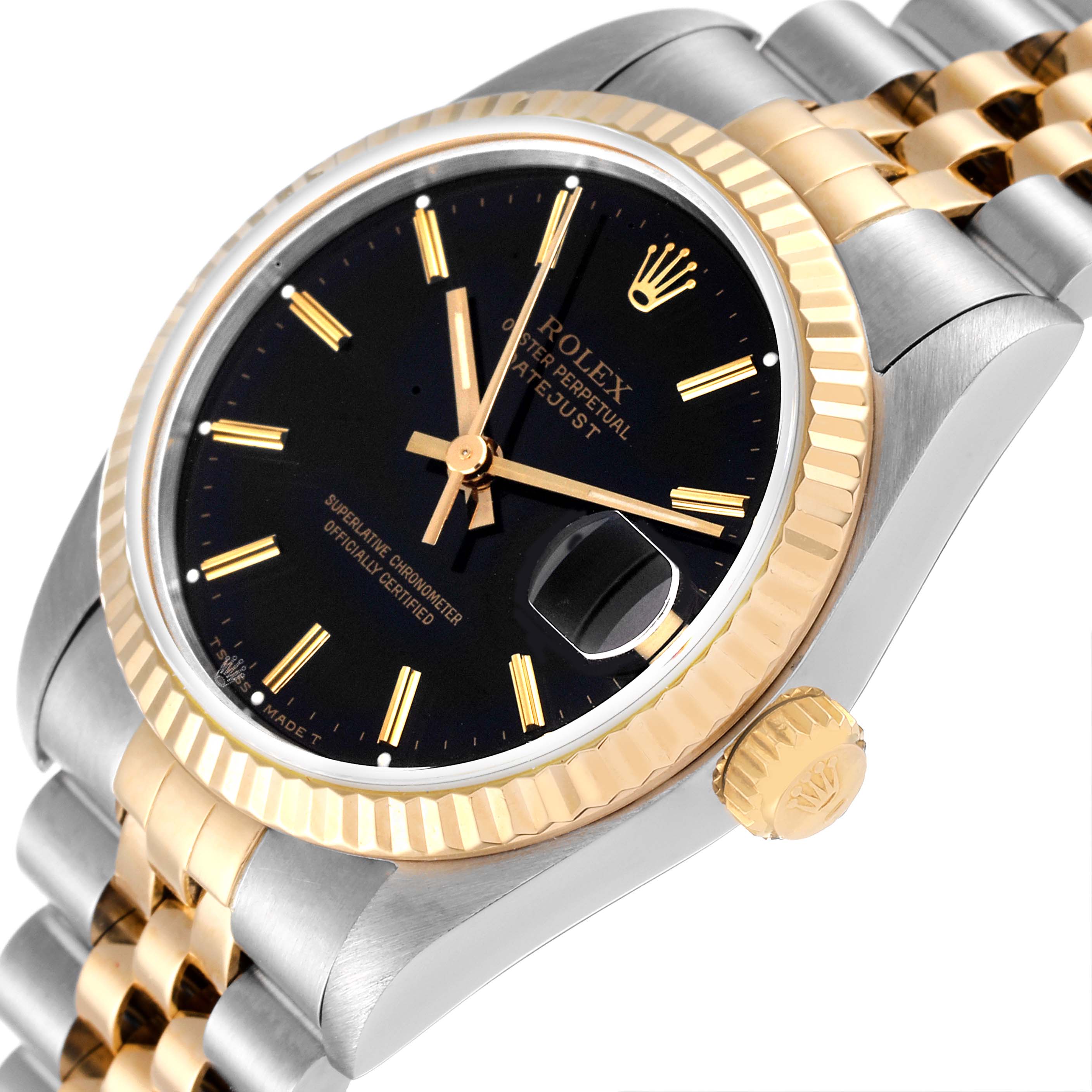 The image shows a close-up angle of the Rolex Mid-Size 68273 Women
s Steel and Gold (two tone) Black Dial 68273 Women
s Steel and Gold (two tone) Black Dial Datejust, highlighting the black dial, fluted bezel, and jubilee bracelet.