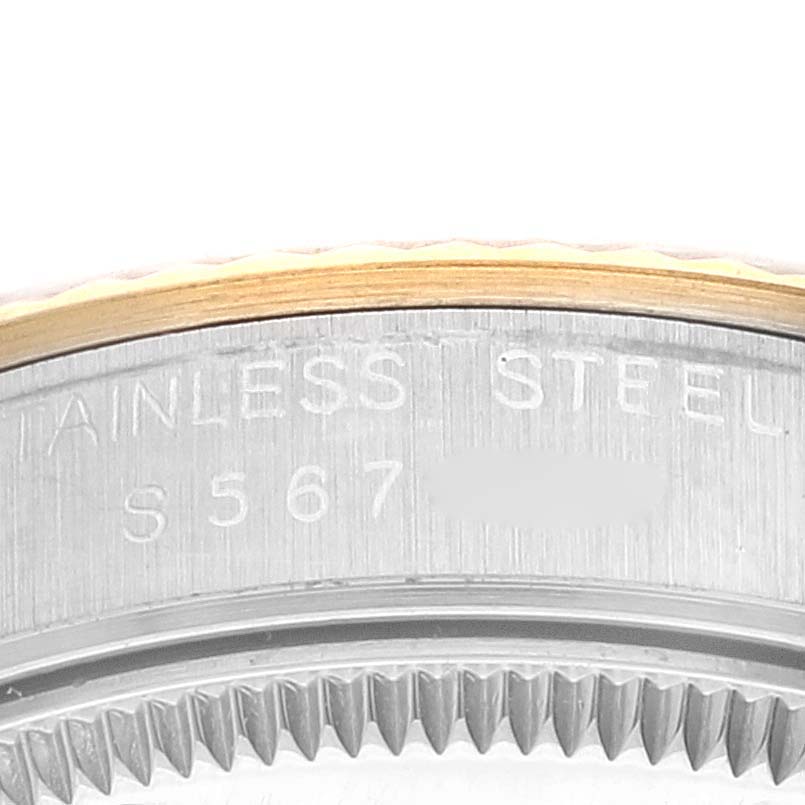 This image shows a close-up of the stainless steel case back and fluted bezel of a Rolex Mid-Size 68273 Women
s Steel and Gold (two tone) Champagne Dial 68273 Women
s Steel and Gold (two tone) Champagne Dial watch.