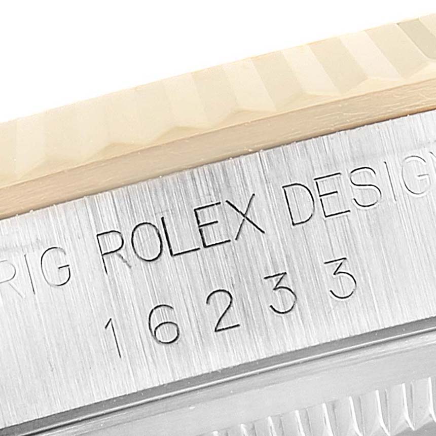 This close-up image shows the side view of a Rolex Datejust 16233 Men's Steel and Gold (two tone) Champagne Dial 16233 Men's Steel and Gold (two tone) Champagne Dial's case, highlighting the engraved model number 16233 and part of the bezel.