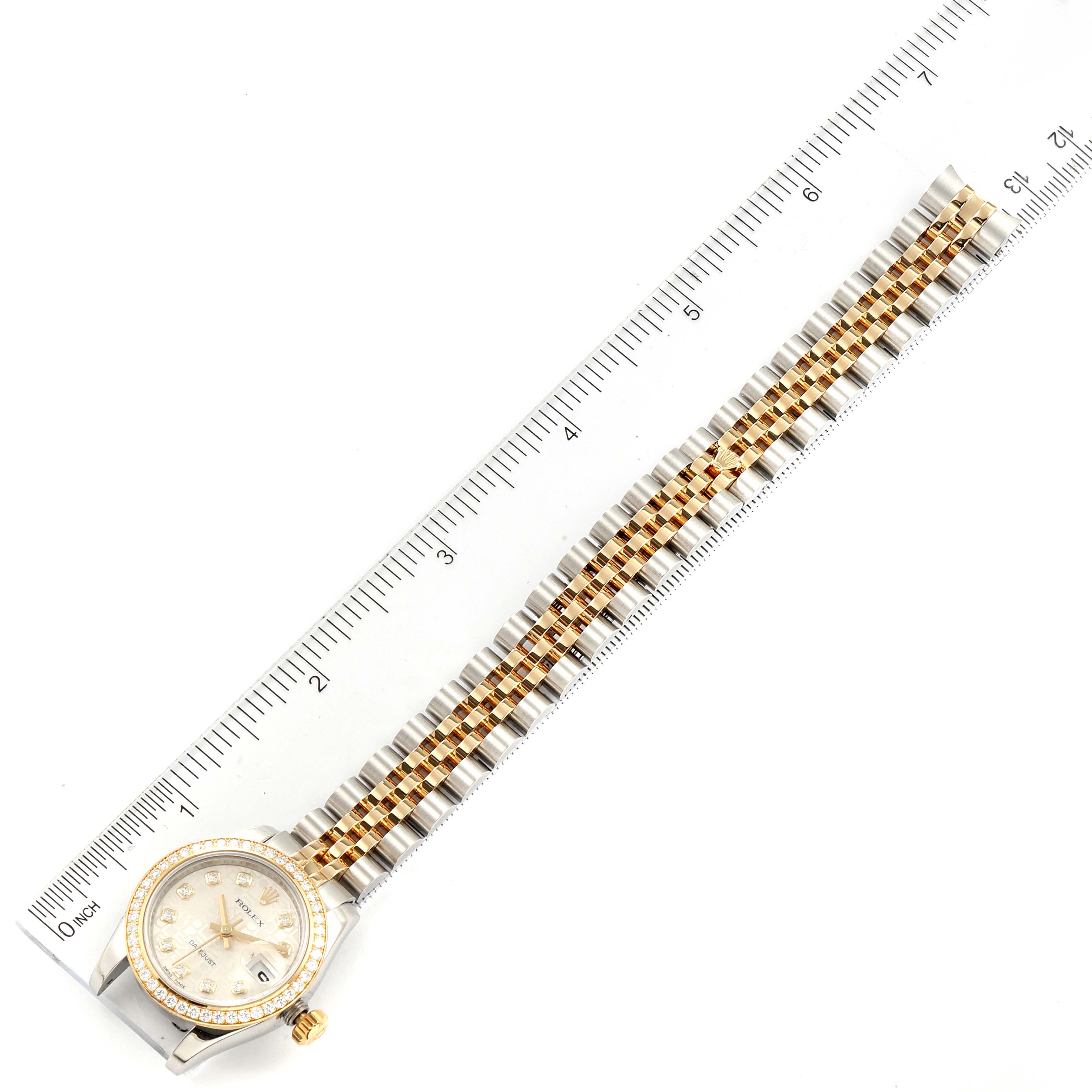 The Rolex Datejust 179383 Women
s Steel and Gold (two tone) Silver Dial 179383 Women
s Steel and Gold (two tone) Silver Dial watch is shown from a top-down angle, alongside a ruler for size reference.