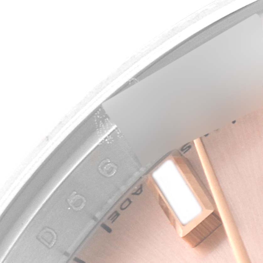 This close-up image shows the dial and part of the bezel of a Rolex Datejust 179171 Women's Steel and Gold (two tone) Pink Dial 179171 Women's Steel and Gold (two tone) Pink Dial watch.