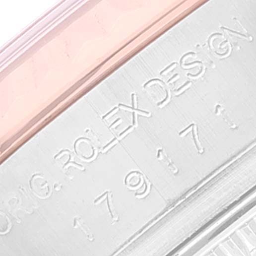 This close-up image shows the engraved serial and model numbering on the side of the Rolex Datejust 179171 Women's Steel and Gold (two tone) Pink Dial 179171 Women's Steel and Gold (two tone) Pink Dial watch case.