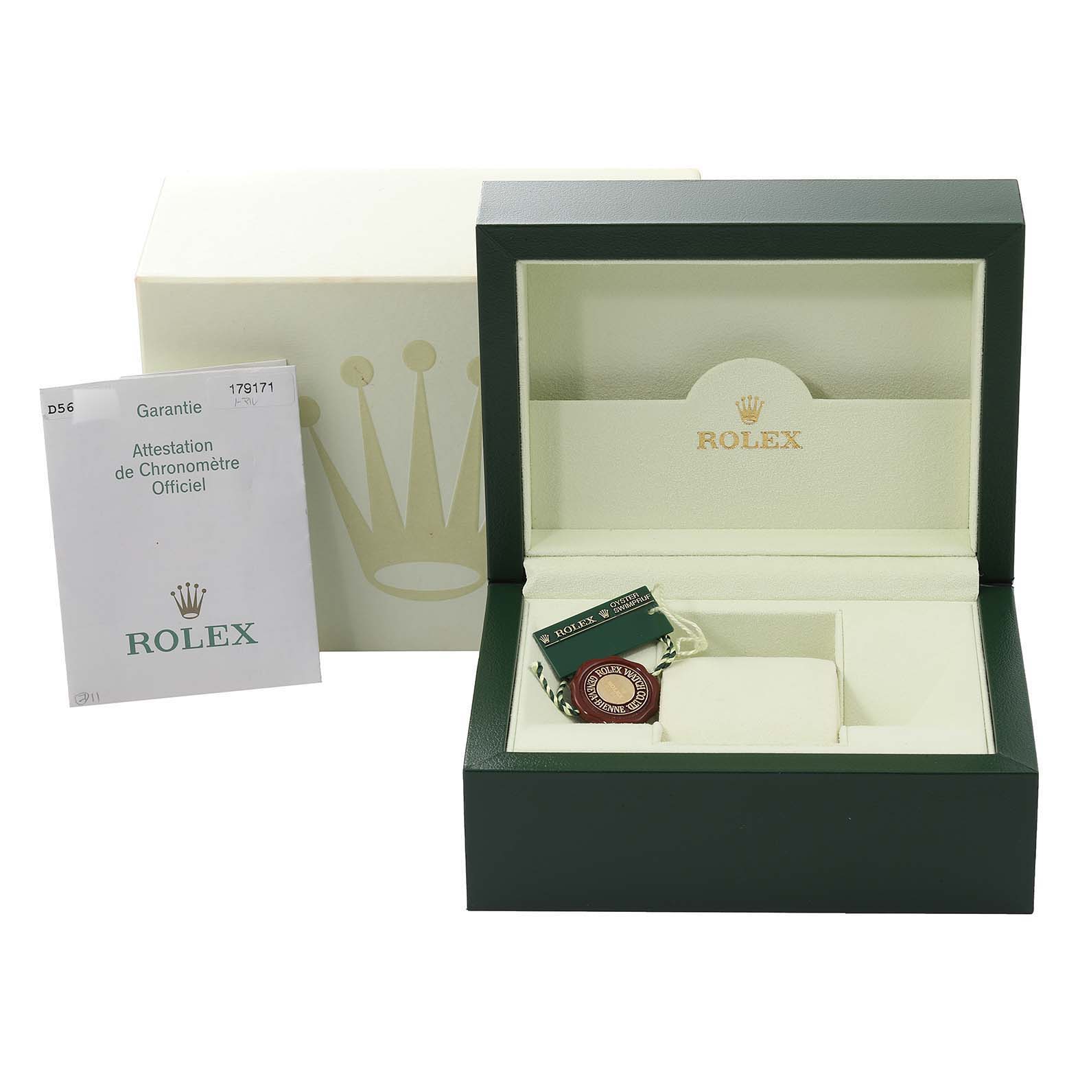 This image shows the open box for a Rolex Datejust 179171 Women's Steel and Gold (two tone) Pink Dial 179171 Women's Steel and Gold (two tone) Pink Dial model, along with a certificate and a tag, viewed from the front.