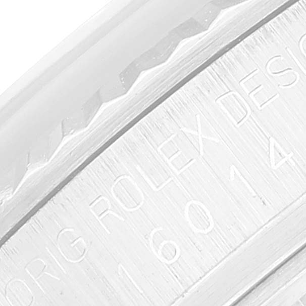 The image shows a close-up of the engraved edge of a Rolex Vintage Collection 16014 Men
s Stainless Steel Silver Dial 16014 Men
s Stainless Steel Silver Dial watch casing.