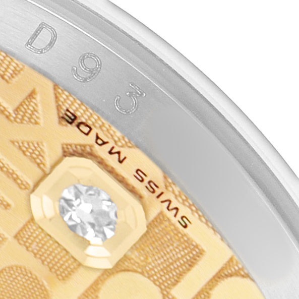 The image shows a close-up of the Rolex Datejust 116233 Men's Steel and Gold (two tone) Champagne Dial dial edge, featuring diamond detailing and partial engraving.
