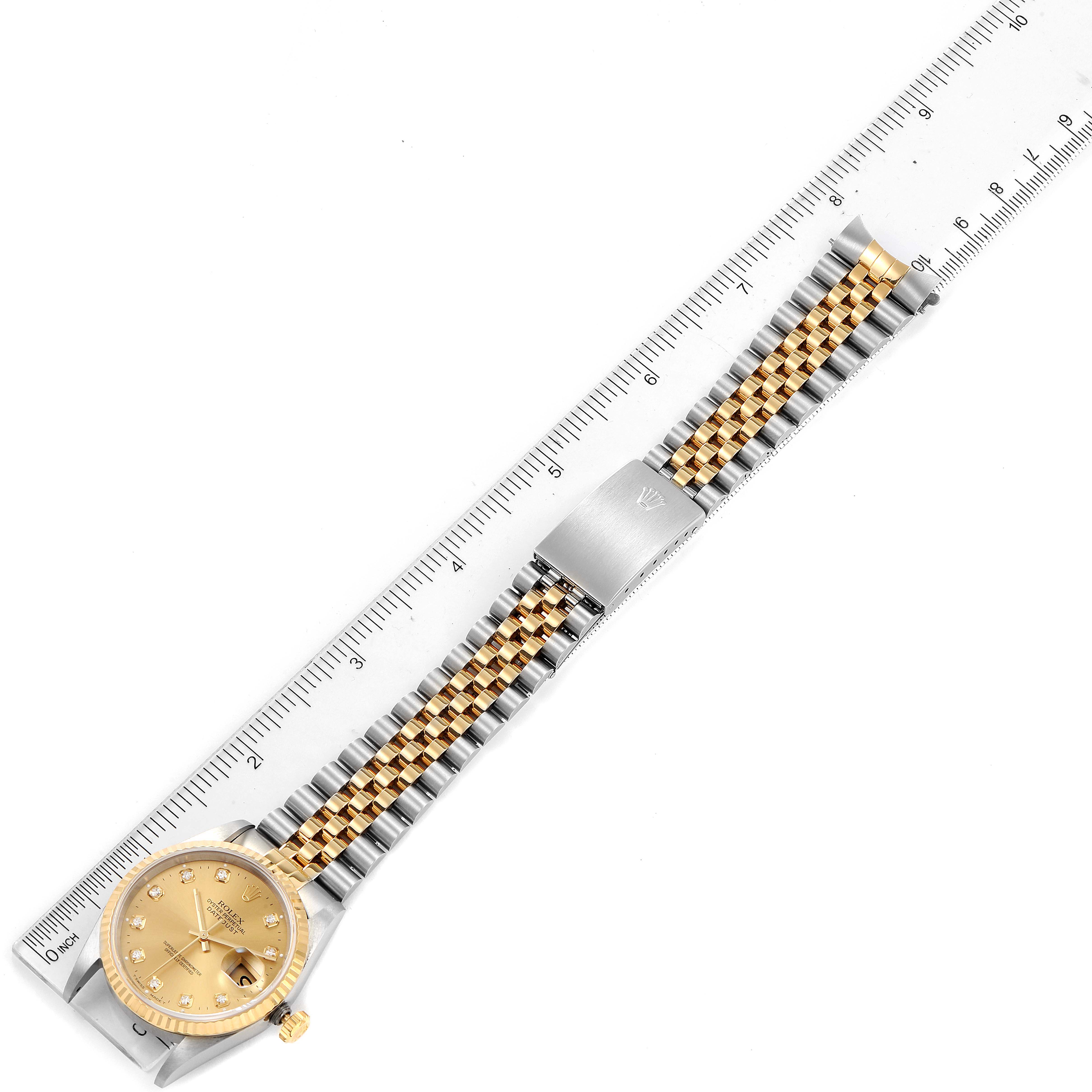 This image shows a Rolex Datejust 16233 Men's Steel and Gold (two tone) Champagne Dial 16233 Men's Steel and Gold (two tone) Champagne Dial watch laid flat, displaying the face, bracelet, and clasp, with a ruler for scale.