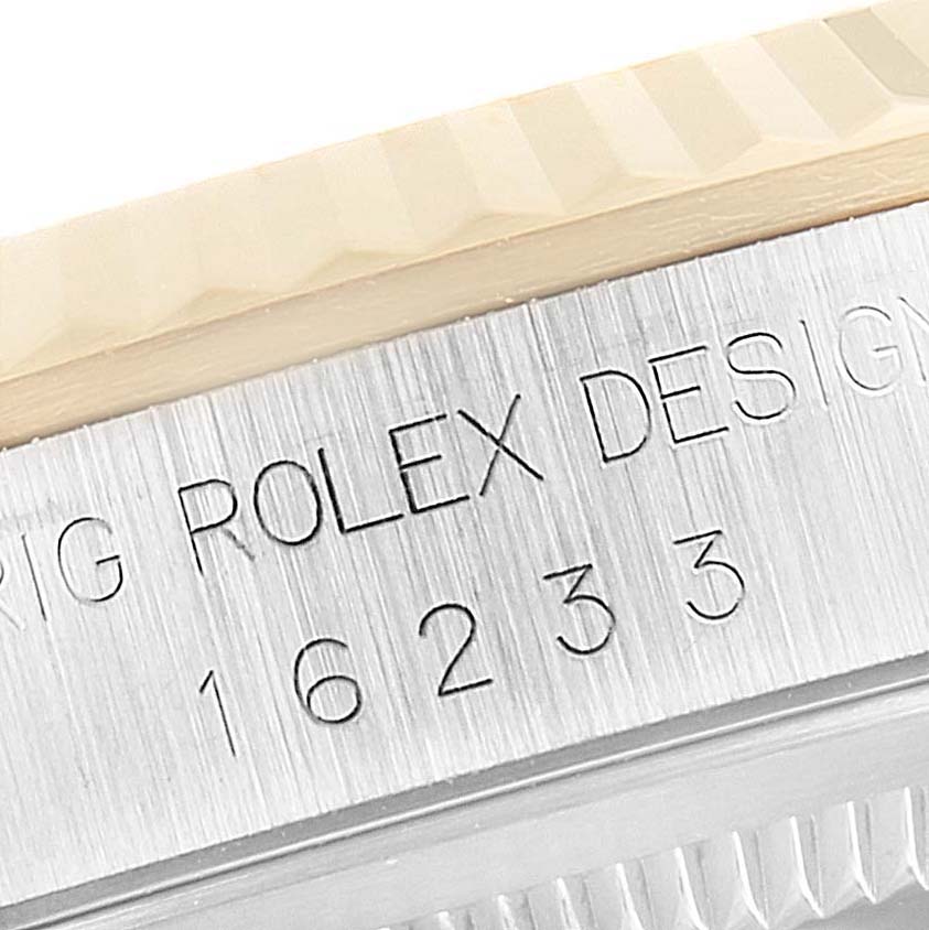 The image shows a close-up of the engraved model number "16233" and part of the bezel of a Rolex Datejust 16233 Men's Steel and Gold (two tone) Champagne Dial 16233 Men's Steel and Gold (two tone) Champagne Dial watch.
