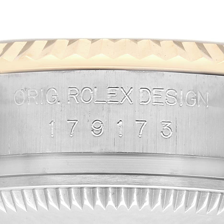 The image shows a side angle of the case edge and bezel, revealing the Rolex Datejust 179173 Women's Steel and Gold (two tone) Black Dial model number and "ORIG. ROLEX DESIGN" engraving.