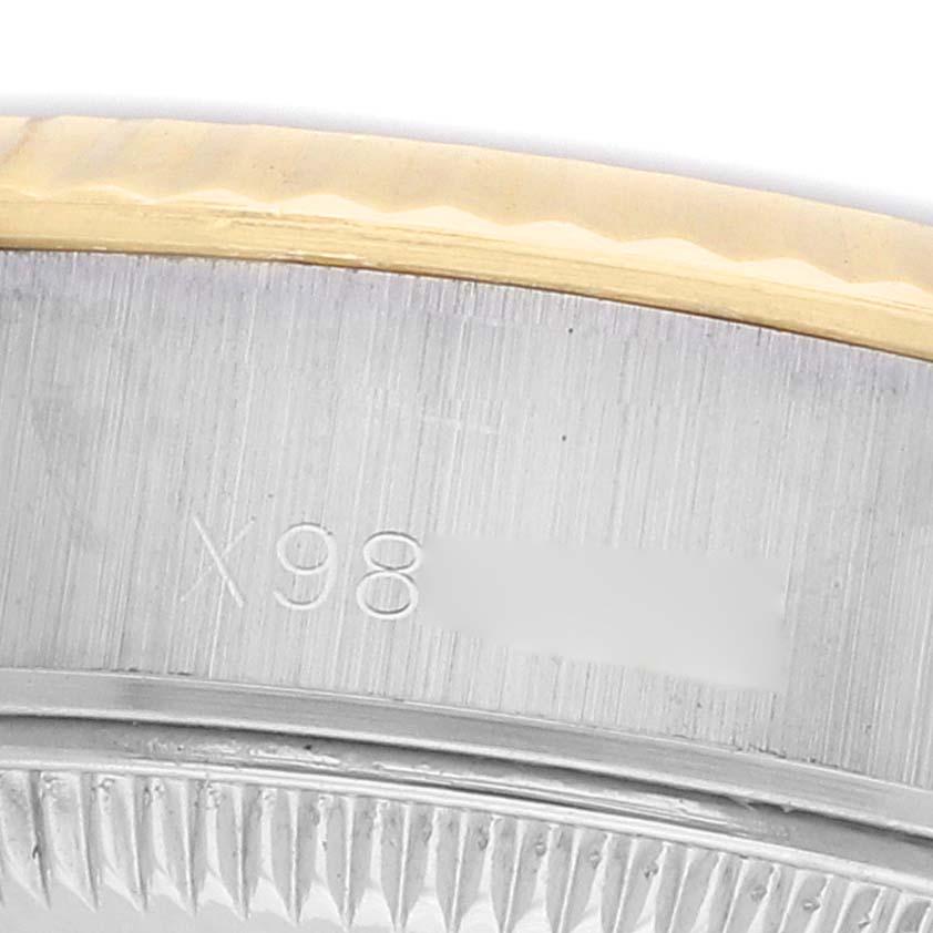 The image shows a close-up of the Datejust model by Rolex focusing on the case edge and part of the fluted bezel.