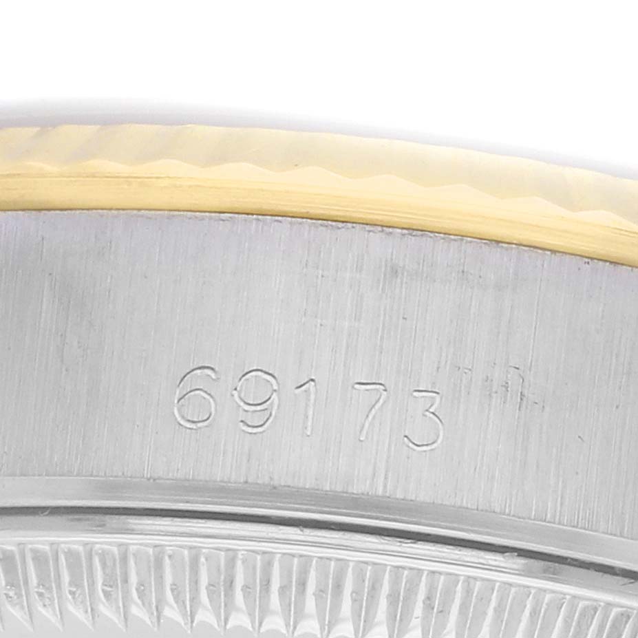 The image shows a close-up of the Rolex Datejust 69173 Women's Steel and Gold (two tone) Champagne Dial model's case side, showcasing the reference number and part of the bezel.