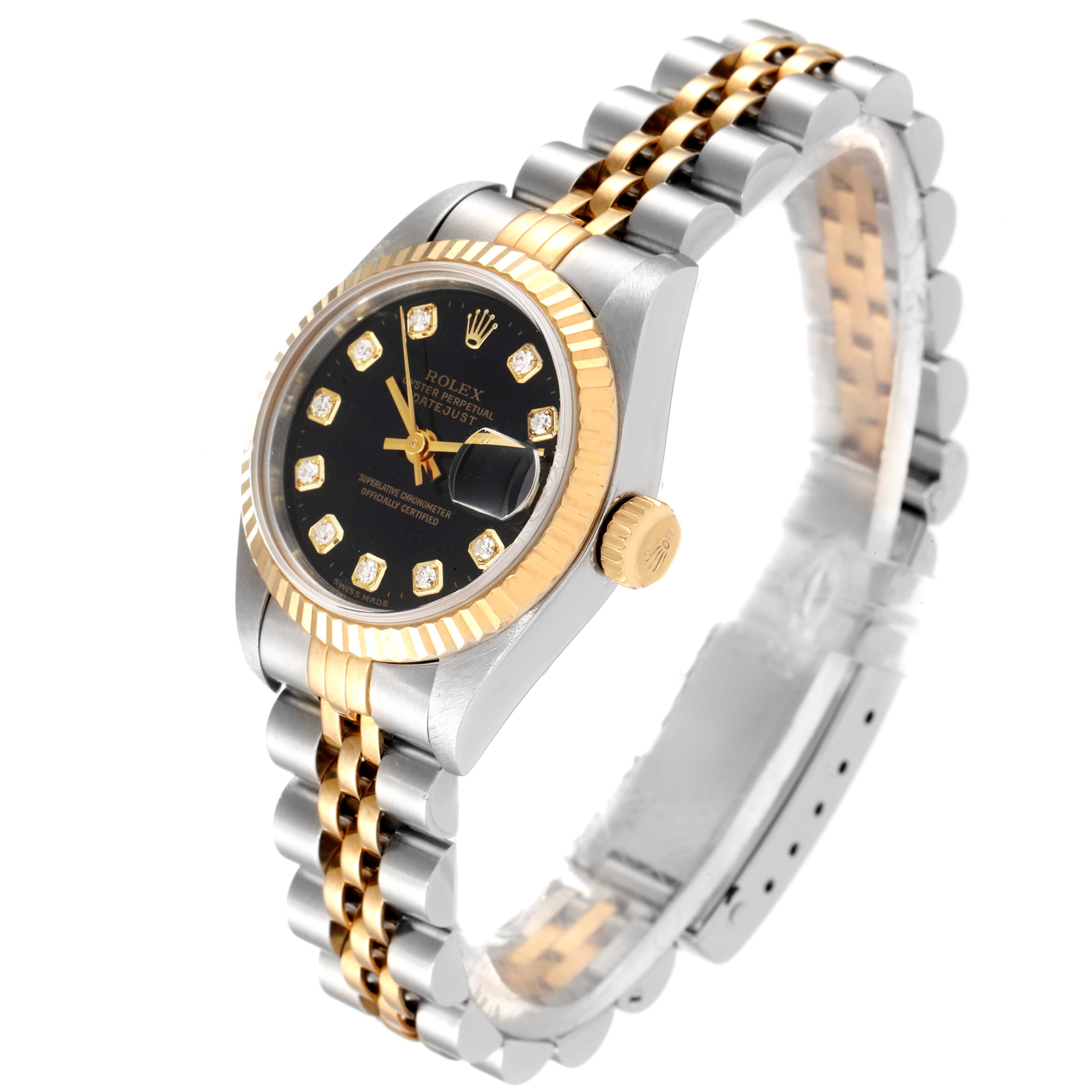 This image shows a Rolex Datejust 79173 Women
s Steel and Gold (two tone) Black Dial 79173 Women
s Steel and Gold (two tone) Black Dial watch at an angle, highlighting the black dial, gold bezel, crown, and two-tone bracelet.