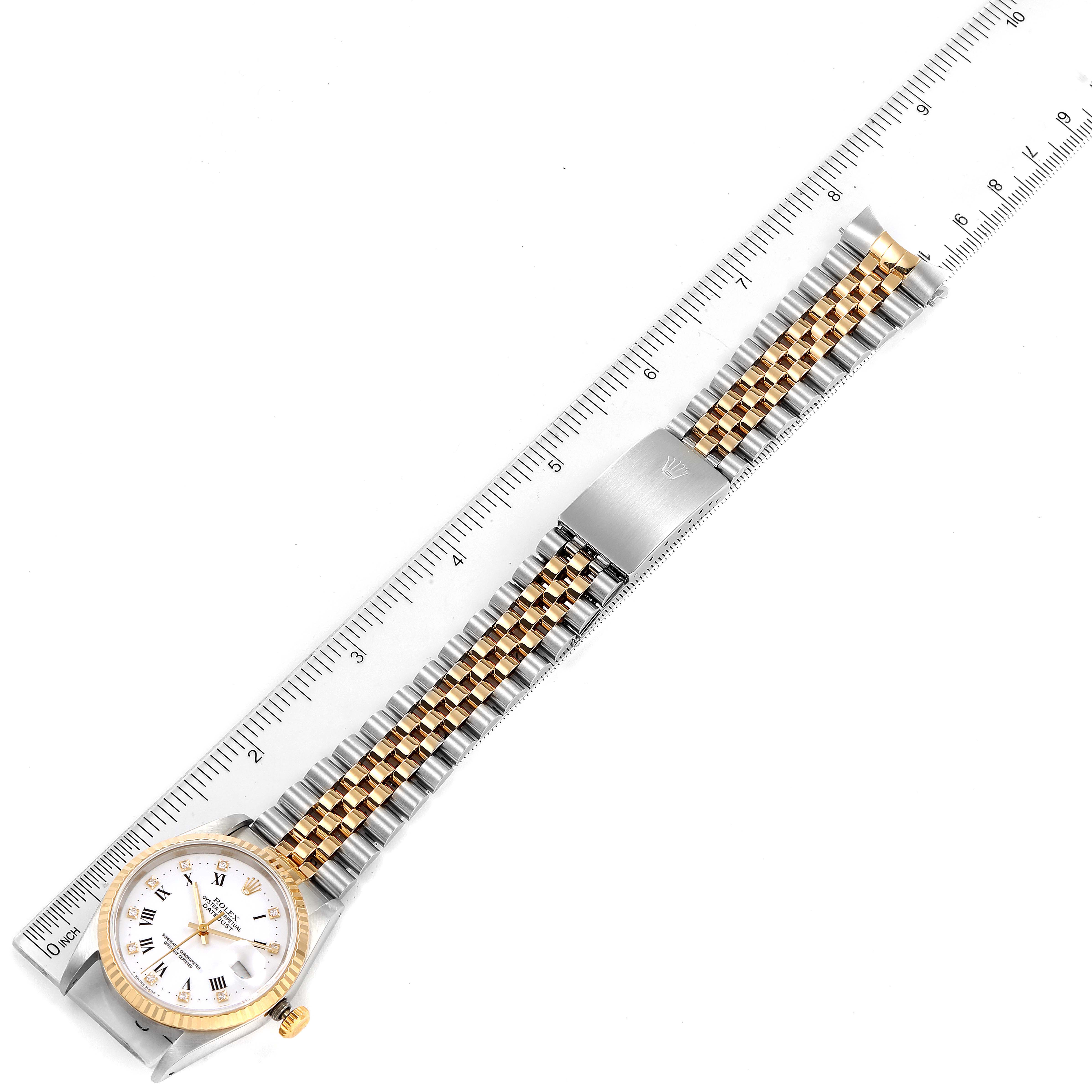 The image shows a Rolex Datejust 16233 Men's Steel and Gold (two tone) White Dial 16233 Men's Steel and Gold (two tone) White Dial watch fully extended, including the face, bracelet, and clasp, aligned with a ruler.