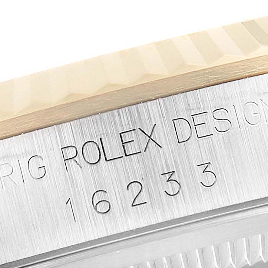 This close-up image shows the bezel and part of the casing with the engraving of the Rolex Datejust 16233 Men's Steel and Gold (two tone) White Dial 16233 Men's Steel and Gold (two tone) White Dial model.