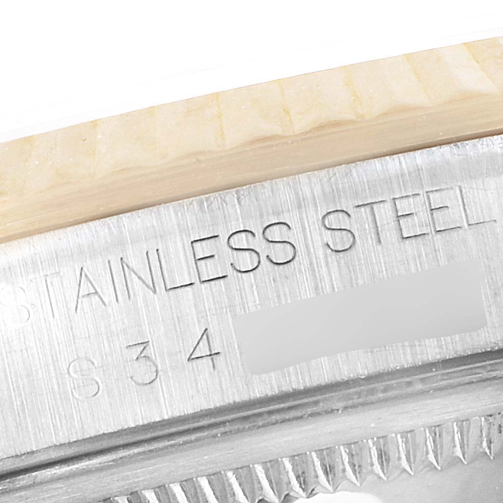 The image shows a close-up of the stainless steel casing with engravings on the Rolex Datejust 16233 Men's Steel and Gold (two tone) White Dial 16233 Men's Steel and Gold (two tone) White Dial watch.