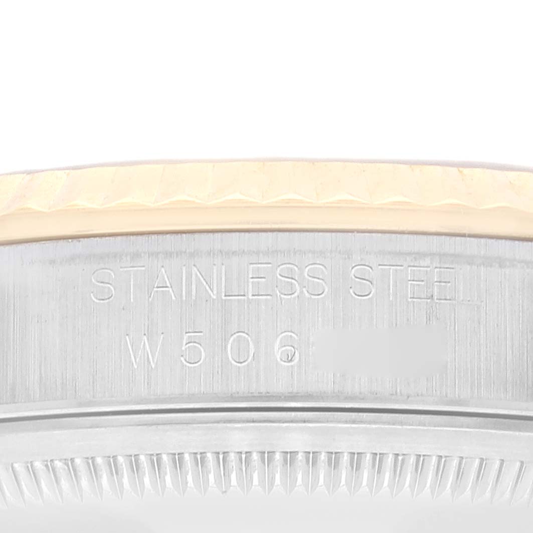 This image shows a close-up of the side and edge of the bezel, and case back rim, displaying text engraved into the metal of a Rolex Datejust 16233 Men's Steel and Gold (two tone) Champagne Dial 16233 Men's Steel and Gold (two tone) Champagne Dial.