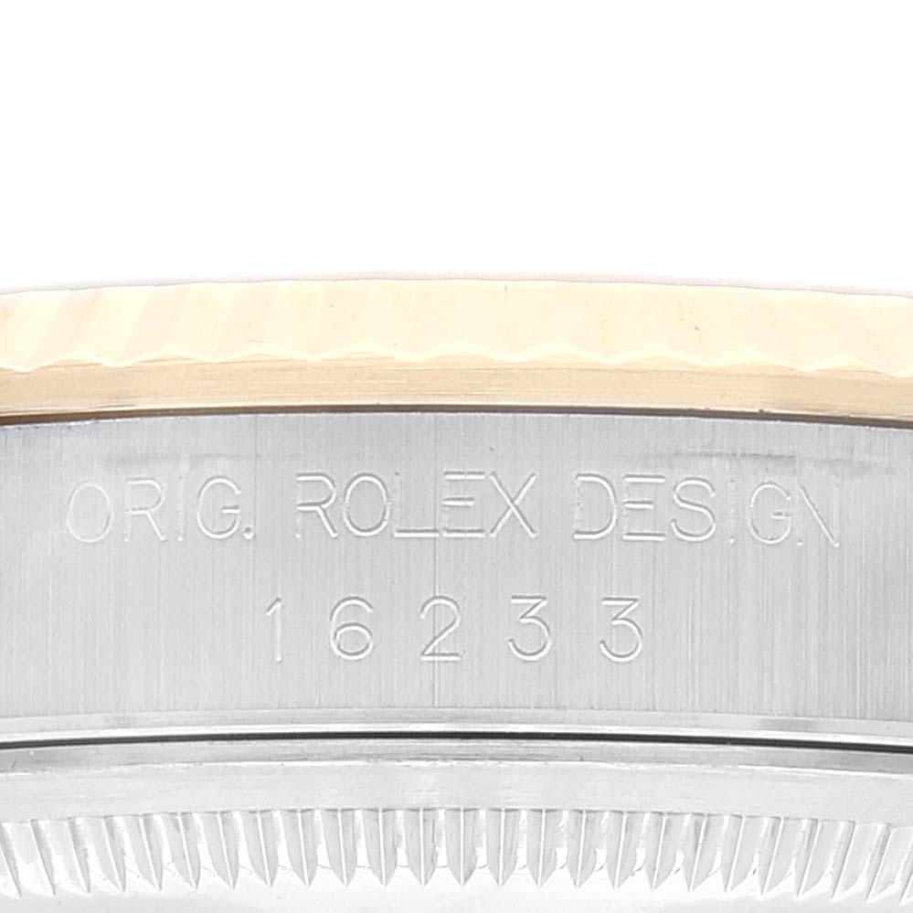 This image shows a close-up of the side of a Rolex Datejust 16233 Men's Steel and Gold (two tone) Champagne Dial 16233 Men's Steel and Gold (two tone) Champagne Dial watch, highlighting its serial number and "ORIG. ROLEX DESIGN" engraving.