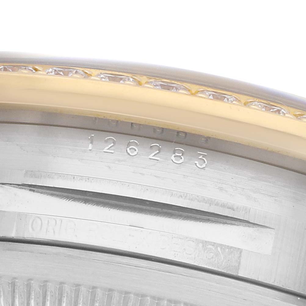 The image shows a close-up of the Rolex Datejust 126283 Men's Steel and Gold (two tone) Mother of Pearl Dial model's case edge, highlighting the serial number and bejeweled bezel.
