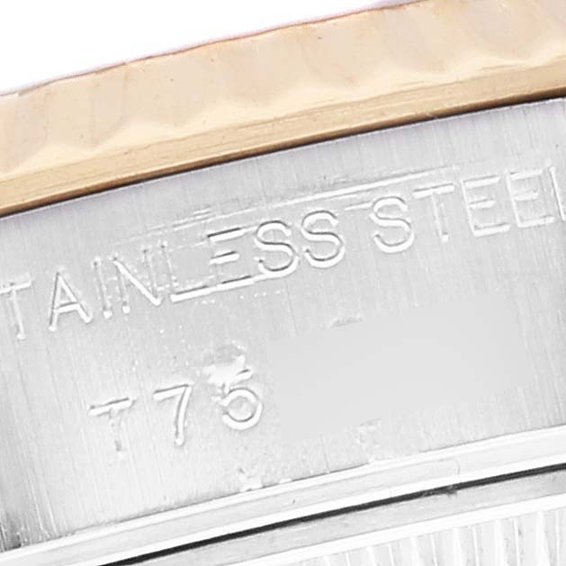 The image shows a close-up of the edge of the bezel and stainless steel case of a Rolex Datejust 69173 Women's Steel and Gold (two tone) Mother of Pearl Dial 69173 Women's Steel and Gold (two tone) Mother of Pearl Dial watch.