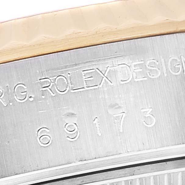 This image shows a close-up view of the Rolex Datejust 69173 Women's Steel and Gold (two tone) Mother of Pearl Dial 69173 Women's Steel and Gold (two tone) Mother of Pearl Dial model's case side, featuring the model number and "ROLEX DESIGN" engraving.
