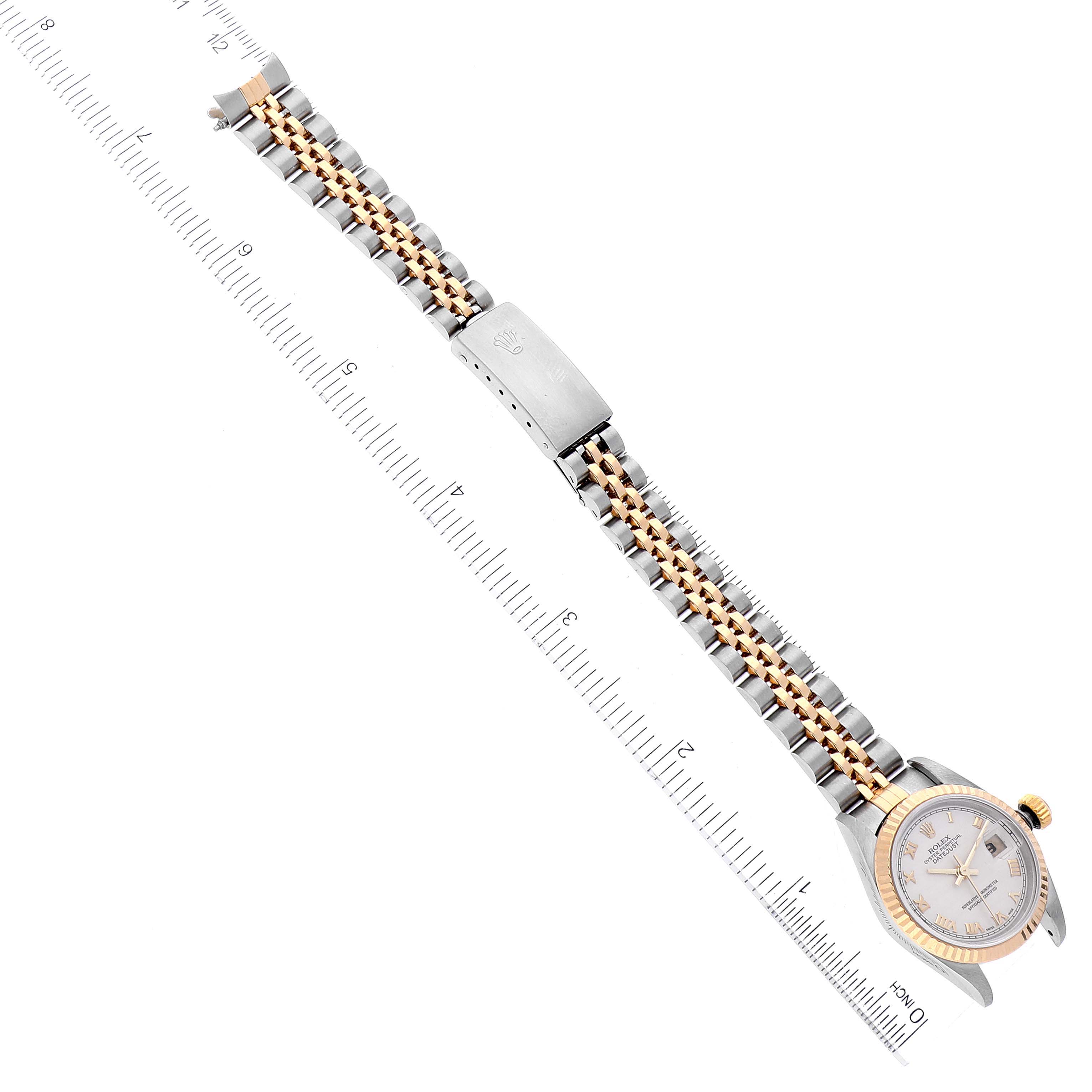 The image shows a Rolex Datejust 79173 Women's Steel and Gold (two tone) Beige Dial 79173 Women's Steel and Gold (two tone) Beige Dial watch with its strap fully extended and placed next to a ruler.