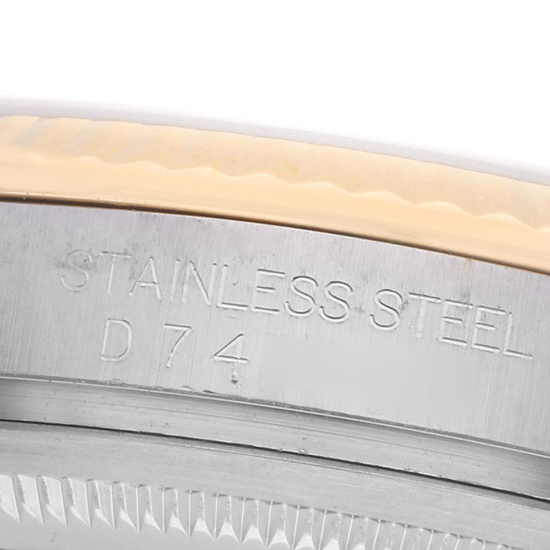 The image shows a close-up of the stainless steel case back edge of a Rolex Datejust 116233 Men's Steel and Gold (two tone) White Dial watch.