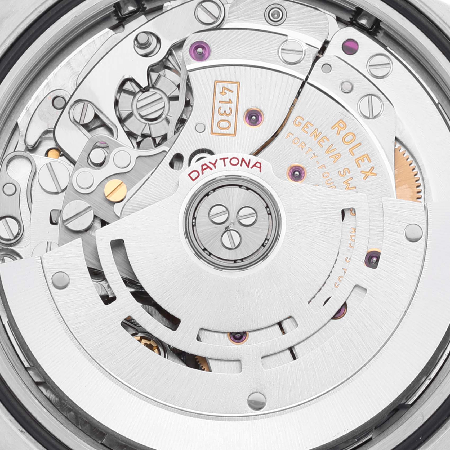 The image shows a close-up view of the movement and intricate mechanics inside a Rolex Daytona 116520 Men
s Stainless Steel White Dial 116520 Men
s Stainless Steel White Dial watch, highlighting the rotor and gears.