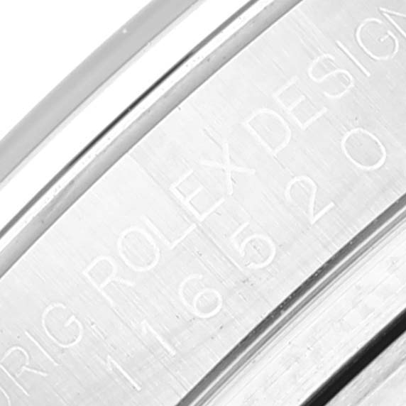 The image shows a close-up of the engraved side of a Rolex Daytona 116520 Men
s Stainless Steel White Dial 116520 Men
s Stainless Steel White Dial watch case.