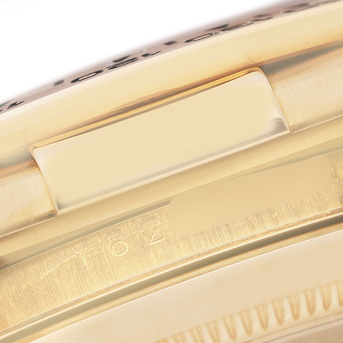 The image shows a close-up of the side of a Rolex Daytona 116518 Men's Yellow Gold Mother of Pearl Dial watch, focusing on part of the bezel and case.