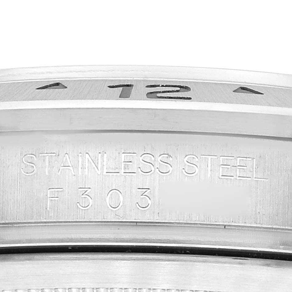 The image shows a close-up view of the bezel and part of the case of a Rolex Explorer 16570 Men
s Stainless Steel Black Dial 16570 Men
s Stainless Steel Black Dial watch, featuring stainless steel material.