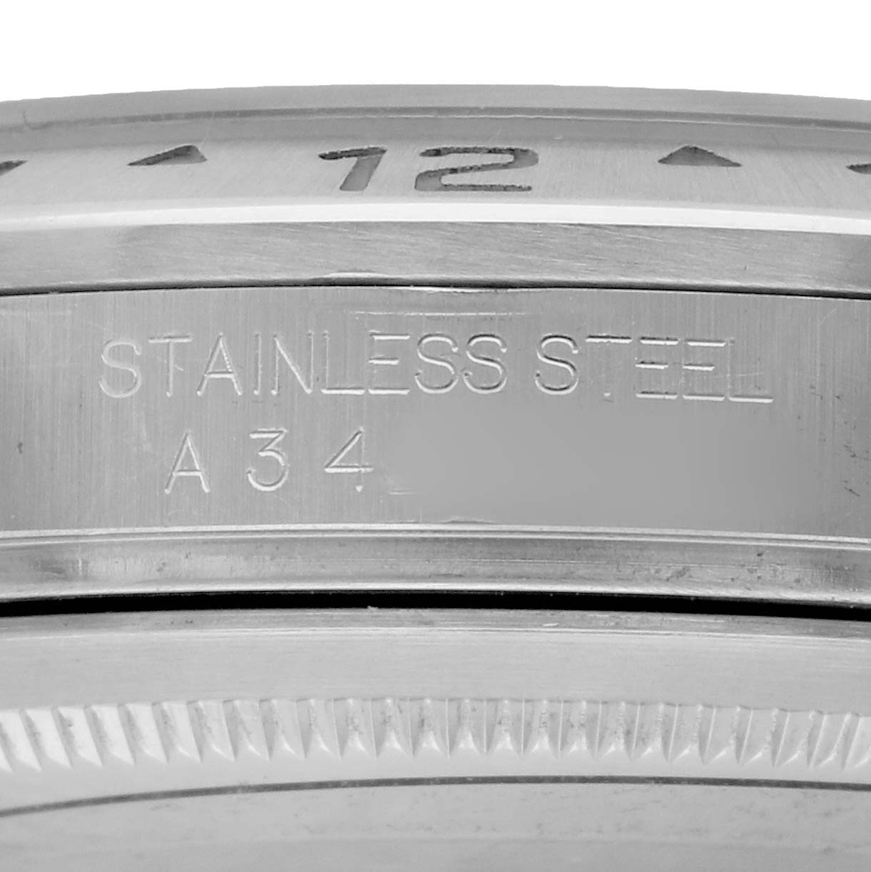 The image shows a close-up of the Rolex Explorer 16570 Men
s Stainless Steel Black Dial
s stainless steel bezel and case with engraved details.