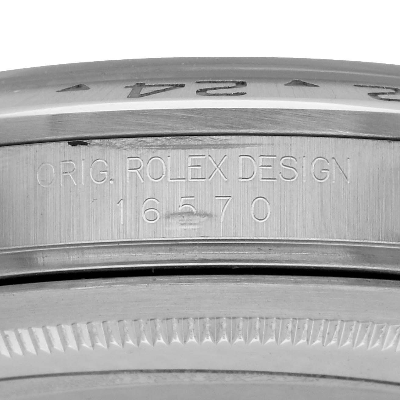 The image shows a close-up of the side view of the Rolex Explorer 16570 Men
s Stainless Steel Black Dial model
s bezel and engraved design number.